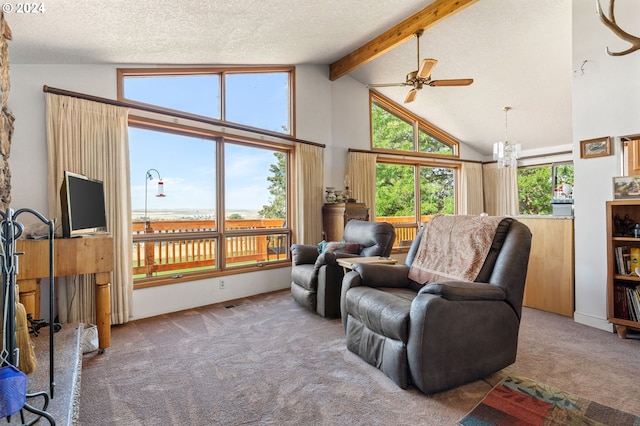 living room with carpet floors, ceiling fan, a textured ceiling, and beam ceiling