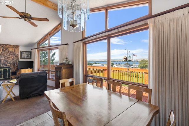 tiled dining room featuring high vaulted ceiling, ceiling fan, beamed ceiling, and a water view