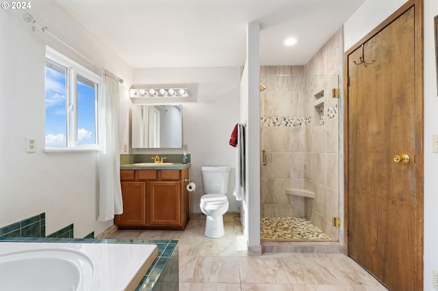 full bathroom featuring toilet, shower with separate bathtub, and vanity