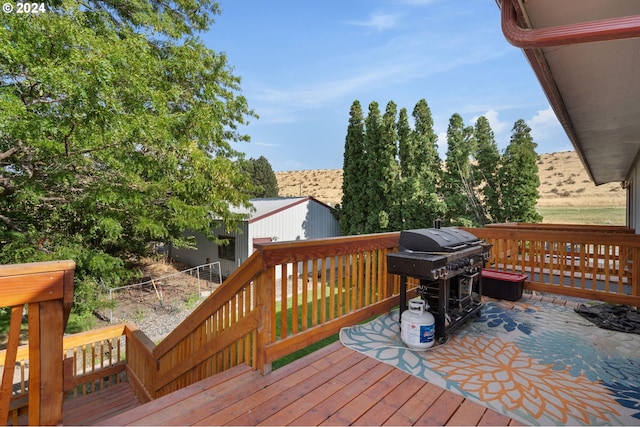 wooden deck featuring a grill