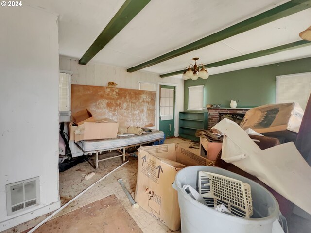 misc room featuring a notable chandelier and beam ceiling