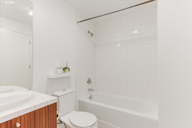 full bathroom with vanity, toilet, and tiled shower / bath