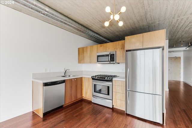 kitchen featuring dark hardwood / wood-style flooring, sink, a notable chandelier, and appliances with stainless steel finishes