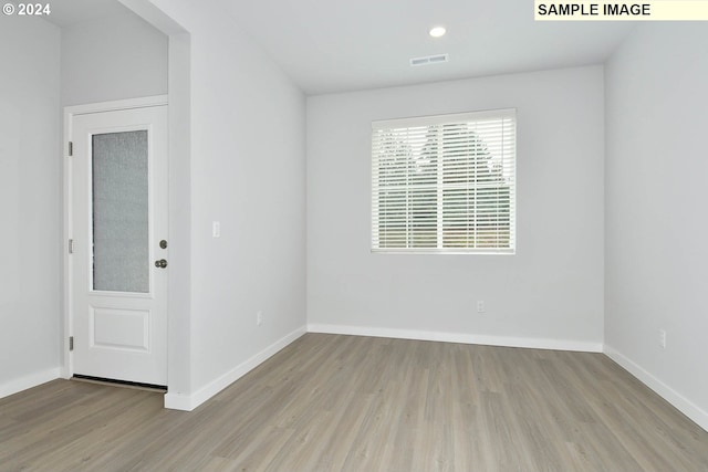 spare room with light wood-type flooring