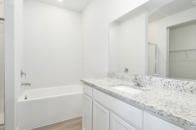 full bathroom featuring shower / bathing tub combination, vanity with extensive cabinet space, and toilet