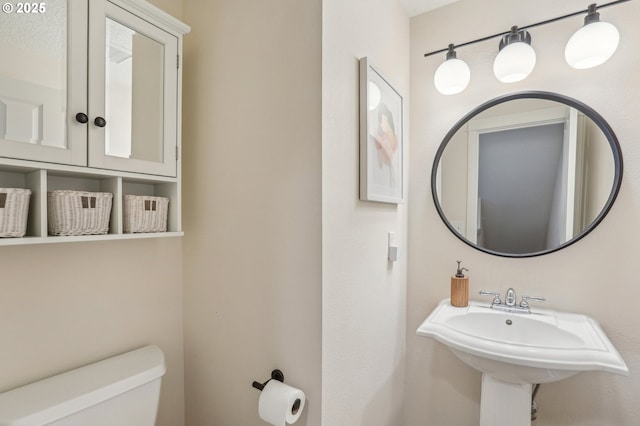 bathroom featuring sink and toilet