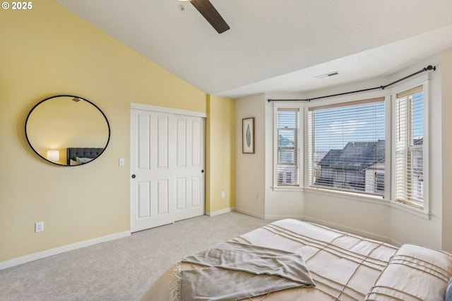 bedroom featuring lofted ceiling, multiple windows, a closet, and ceiling fan