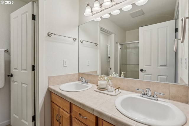 bathroom featuring walk in shower and vanity