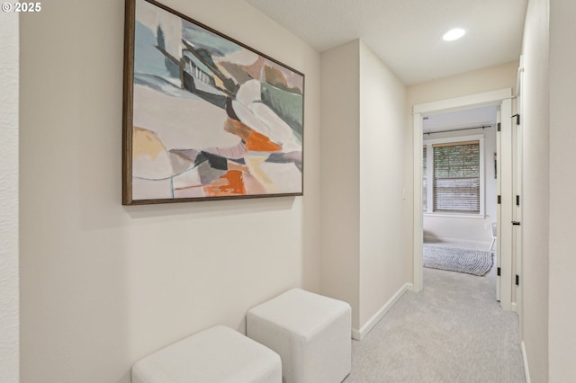 hallway with light colored carpet