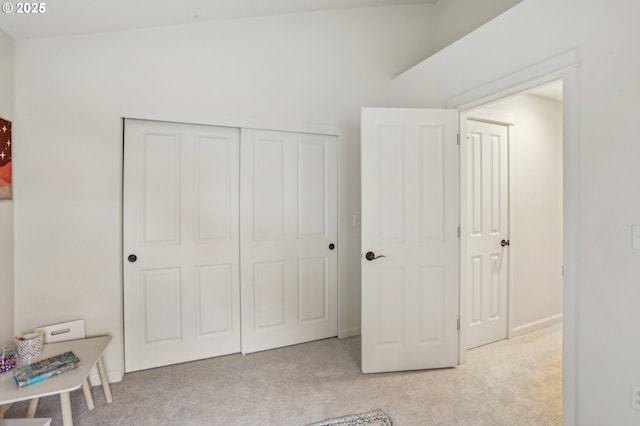 bedroom with light colored carpet and a closet