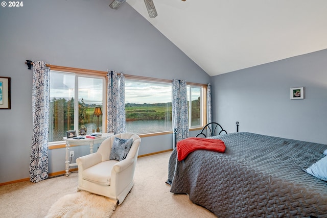 bedroom featuring light colored carpet, multiple windows, and high vaulted ceiling