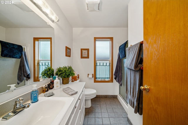 bathroom with tile patterned floors, vanity, toilet, and an enclosed shower