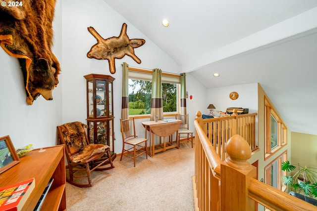 living area featuring vaulted ceiling and light carpet