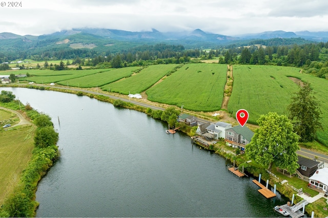 aerial view with a water and mountain view and a rural view