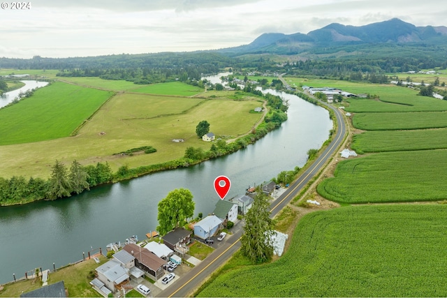 birds eye view of property featuring a water and mountain view and a rural view