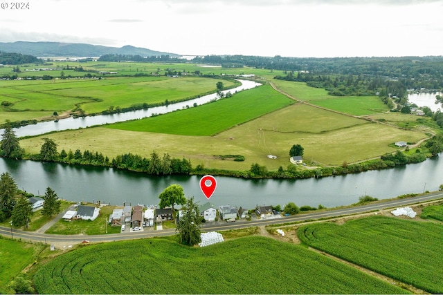 birds eye view of property featuring a water and mountain view and a rural view