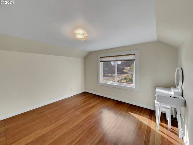 bonus room featuring wood-type flooring and vaulted ceiling