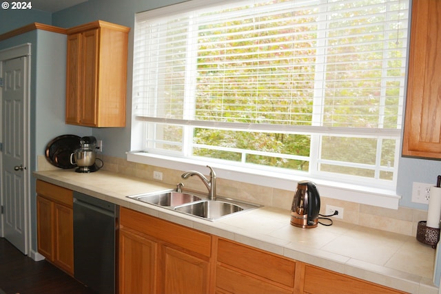 kitchen with tile countertops, dishwasher, sink, and dark hardwood / wood-style flooring