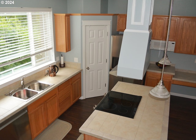 kitchen with stainless steel dishwasher, a sink, white microwave, dark wood finished floors, and cooktop