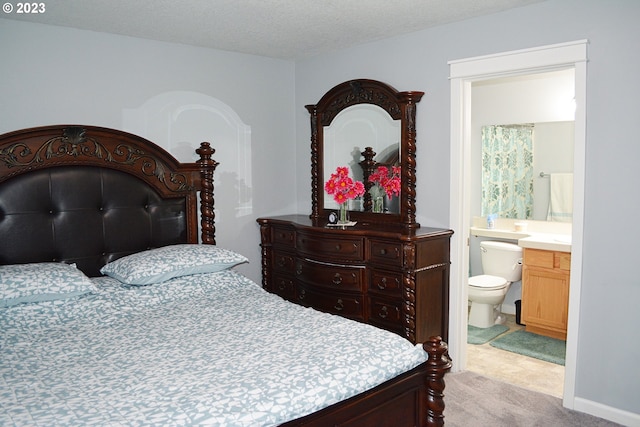 bedroom with carpet flooring and ensuite bath