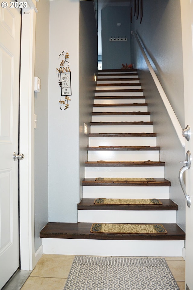 staircase featuring tile patterned floors