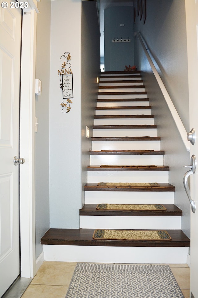 stairs with tile patterned floors