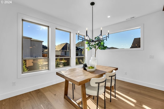 dining room featuring a chandelier and wood-type flooring