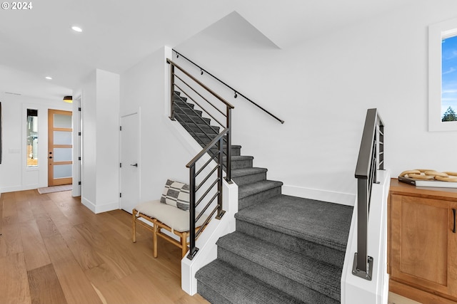 stairway with hardwood / wood-style flooring