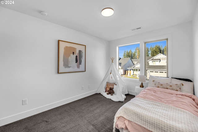 bedroom featuring dark carpet