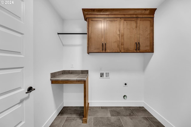 laundry room with hookup for a washing machine, cabinets, and hookup for an electric dryer