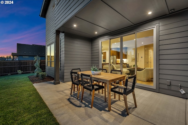 patio terrace at dusk with a lawn