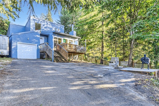 view of front facade featuring a garage and a deck