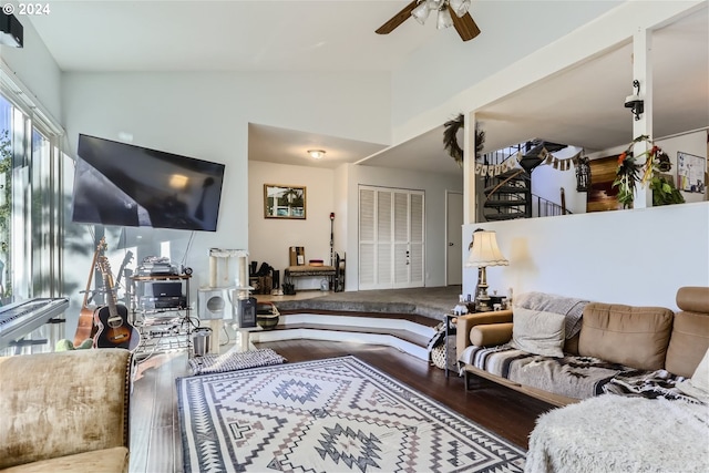 living room featuring ceiling fan, vaulted ceiling, and hardwood / wood-style flooring