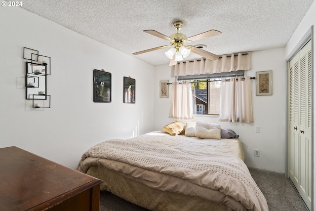 carpeted bedroom featuring ceiling fan, a closet, and a textured ceiling