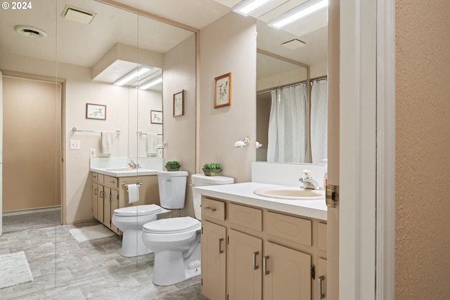 bathroom with visible vents, toilet, and vanity