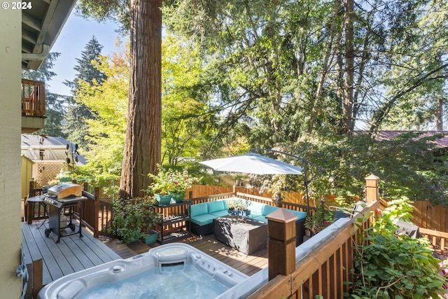 exterior space with area for grilling, fence, hot tub deck surround, and a wooden deck