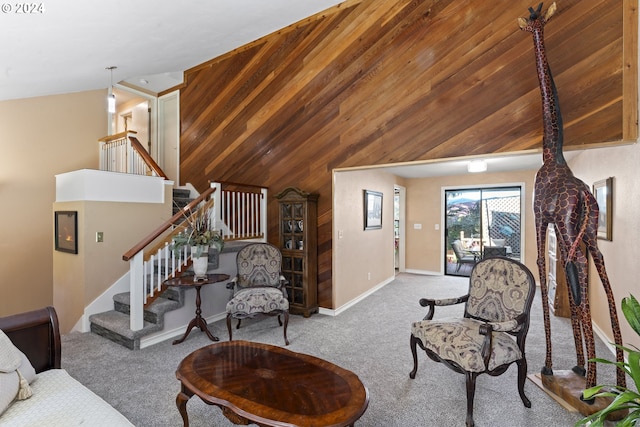 living area featuring stairway, baseboards, carpet floors, high vaulted ceiling, and wood walls