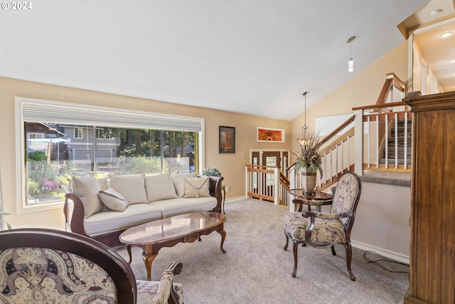 living area featuring baseboards, carpet, a healthy amount of sunlight, and vaulted ceiling