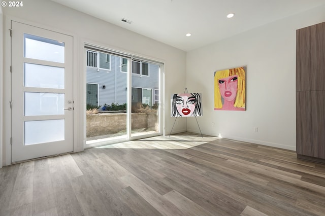 unfurnished room with visible vents, baseboards, light wood-style flooring, and recessed lighting