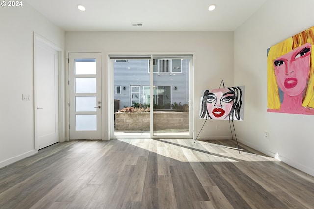 doorway to outside with recessed lighting, wood finished floors, visible vents, and a healthy amount of sunlight