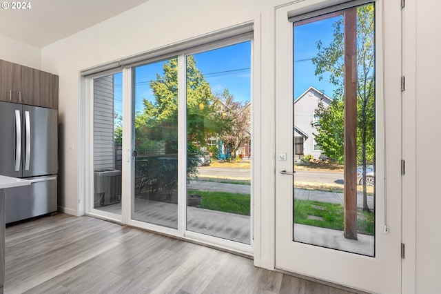 entryway featuring baseboards and light wood finished floors