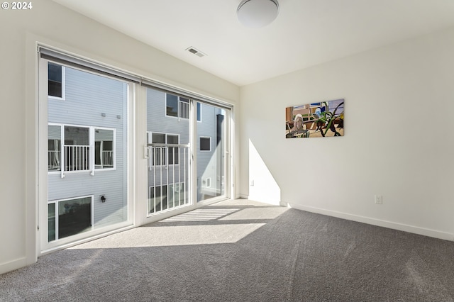 carpeted empty room with baseboards and visible vents