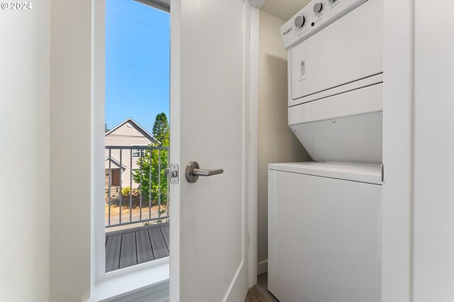 clothes washing area with stacked washer and dryer