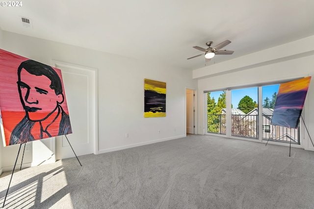 unfurnished living room with ceiling fan and carpet floors