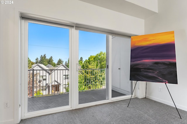 doorway featuring plenty of natural light and carpet flooring