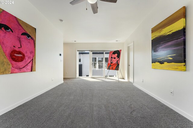 interior space with ceiling fan and carpet