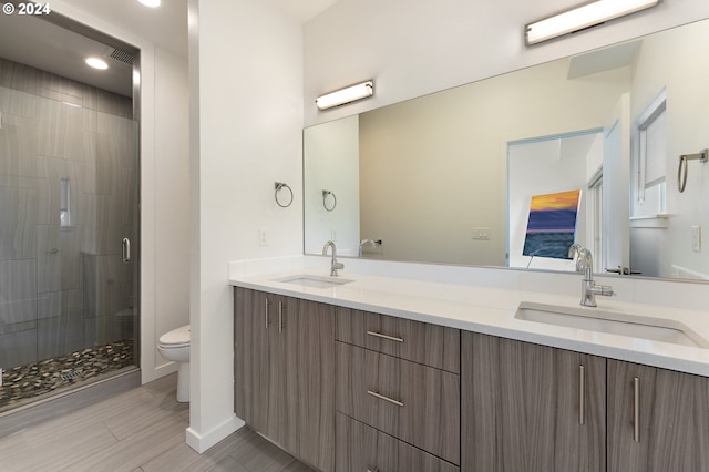 bathroom with vanity, toilet, walk in shower, and tile patterned flooring