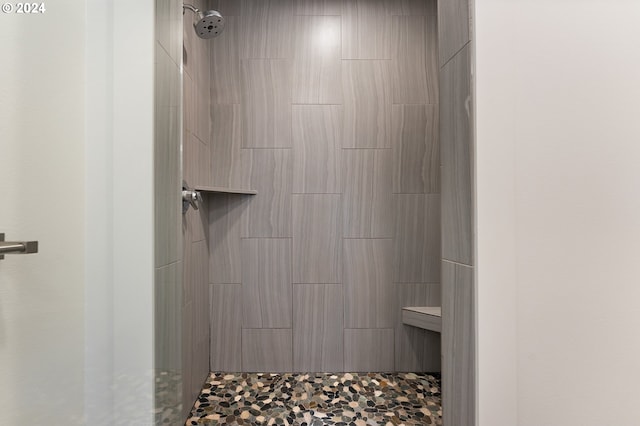 bathroom with a tile shower