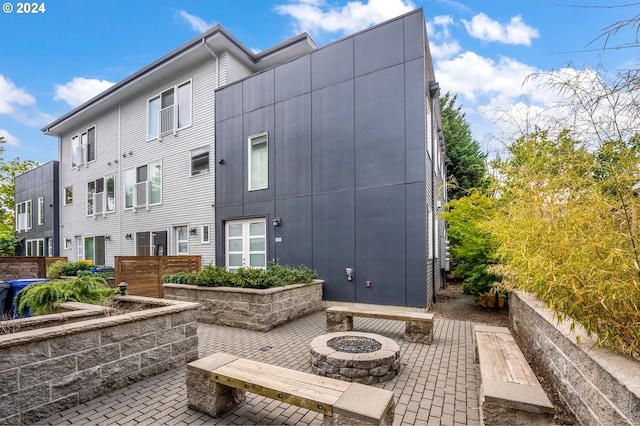 exterior space featuring a patio area and an outdoor fire pit