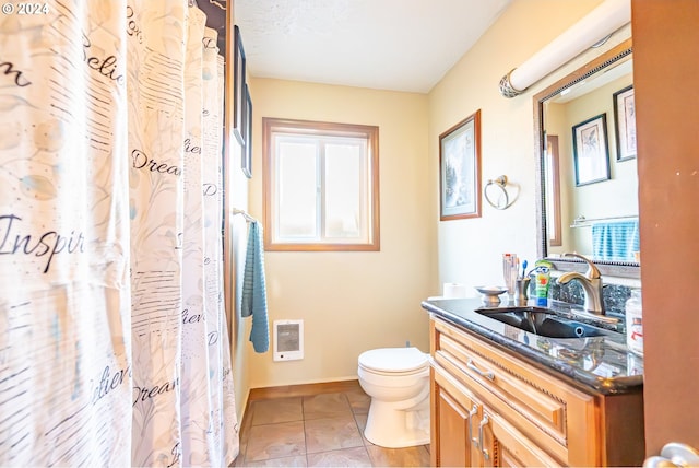 bathroom featuring tile patterned flooring, vanity, and toilet